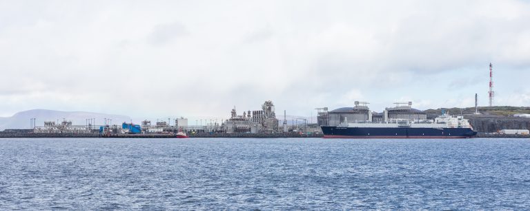 Natural gas industrial supply terminal with LNG tanker illustrative photo